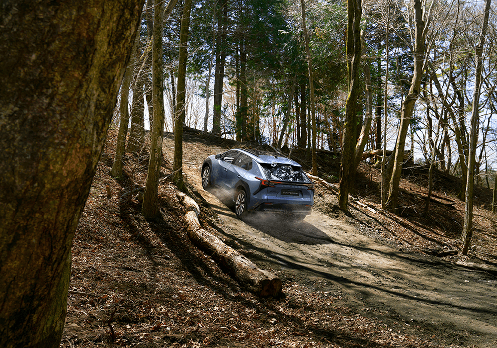 Home 2 A Subaru Solterra on a forest track